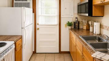 Kitchen with full-size fridge and backyard access