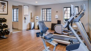 A gym with treadmills, a stationary bike, and a weight bench.