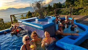 A group of people in a hot tub with a view of mountains.