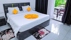 A hotel room with a bed, a balcony with a view, and a window with curtains. - Martin aviator hotel (Kigali)