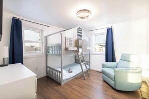 A room with a bunk bed, a desk, a chair, and a window. - Atlantic Inspiration @ Kitty Hawk Ocean Front (Kitty Hawk)