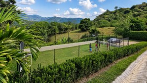 A soccer field with a goalpost, surrounded by greenery and hills in the background. - Private villa with an infinity pool and a sports court · 20 guests (Antioquia)
