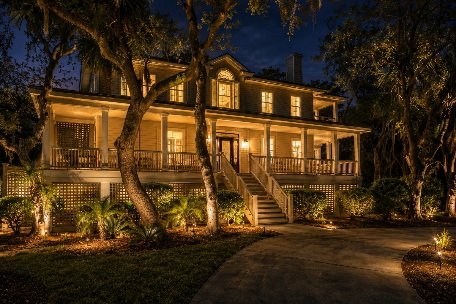 A two-story house with a front porch, a staircase, and a driveway.