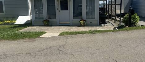 A single-story house with a front porch, a garage, and a covered area with a mailbox.