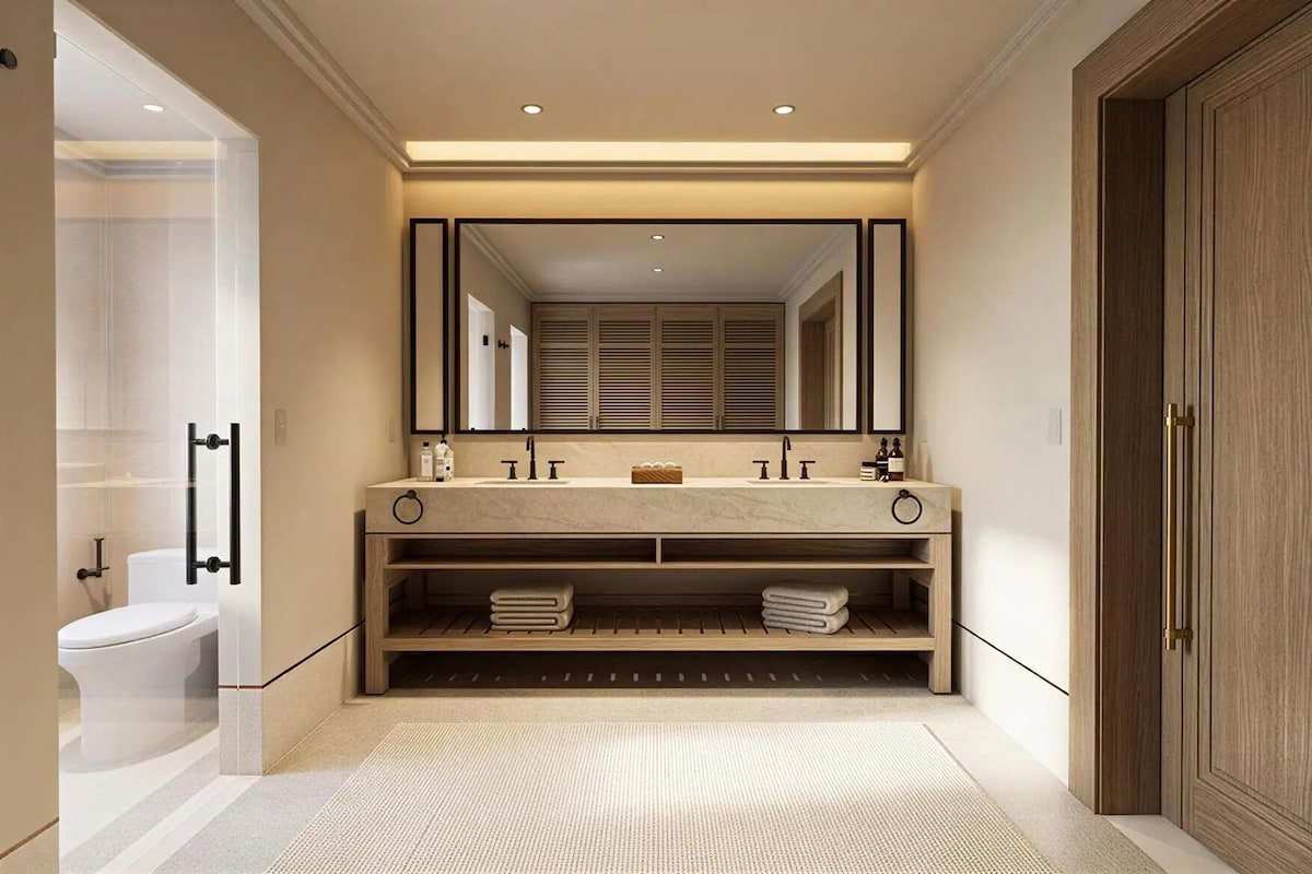A modern bathroom with a large mirror, two sinks, and a wooden vanity.