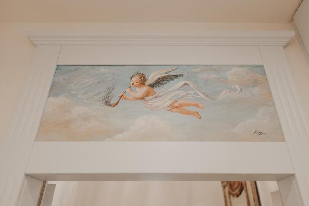 A painting of an angel in a cloud.