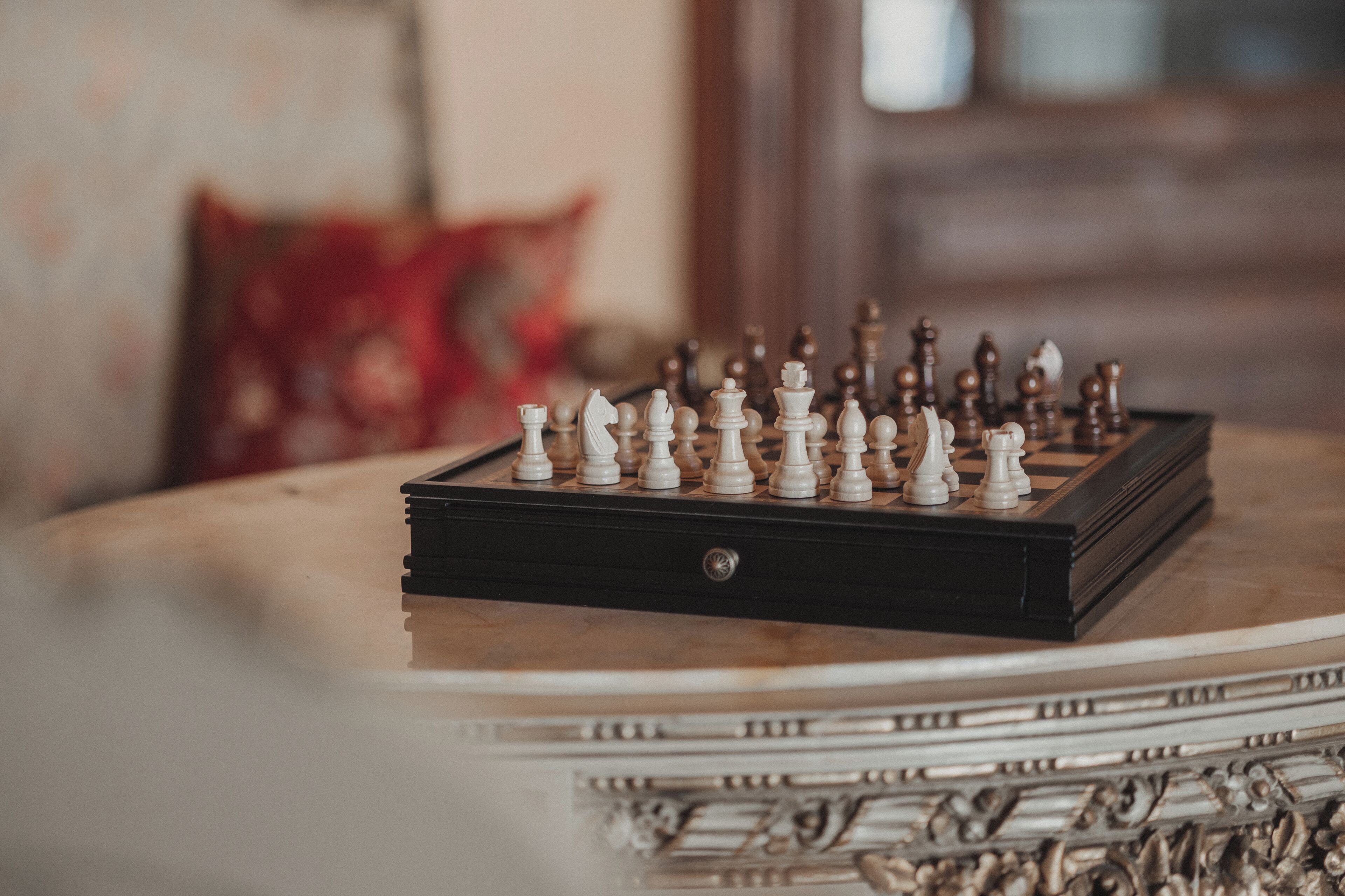 A chessboard on a table with a decorative border.
