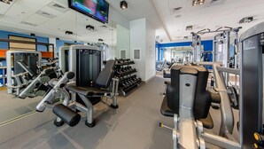 A gym with various exercise machines, a television screen, and a mirror. - Marriott Vacation Club, 1-Bedroom San Diego Suite (San Diego)