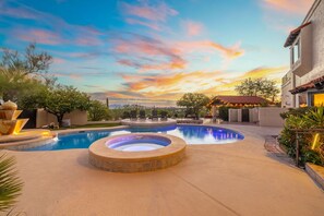 A pool area with hot tubs and a patio, surrounded by landscaping and a building. - Sundance  Resort Style Home in the Foothills (Tucson)