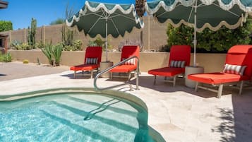 Resort-style pool patio with shaded loungers and sunny desert vibes