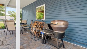 A patio with a grill, chairs, and a table. - Indigo Hideaway | Romantic + Fire pit (Nappanee)