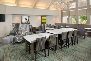 A conference room with a long table, striped chairs, and a patterned carpet. - Residence Inn Detroit Livonia | 2 Studio Queen Rooms | Complimentary Breakfast (Livonia)