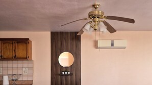 A dining area with a round table, four patterned chairs, a ceiling fan, a mirror, and a wooden cabinet. - San Felipe Condo w/ Shared Pool & Beach Access - Rancho Bugambilias B (San Felipe)