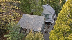 A two-story house with a balcony, surrounded by dense forest. - Crestline Mountain Retreat (Crestline)