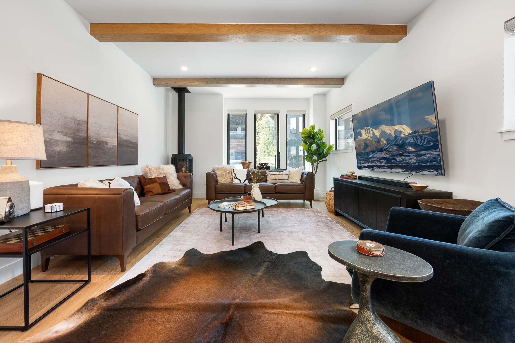 A modern living room with a sofa, coffee table, and a television.