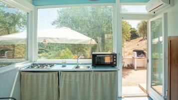 A kitchen with a gas stove, a microwave, and a sink.