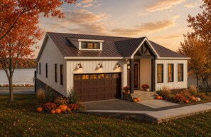 Ein modernes Haus mit Garage, einer kleinen Veranda und Seeblick.