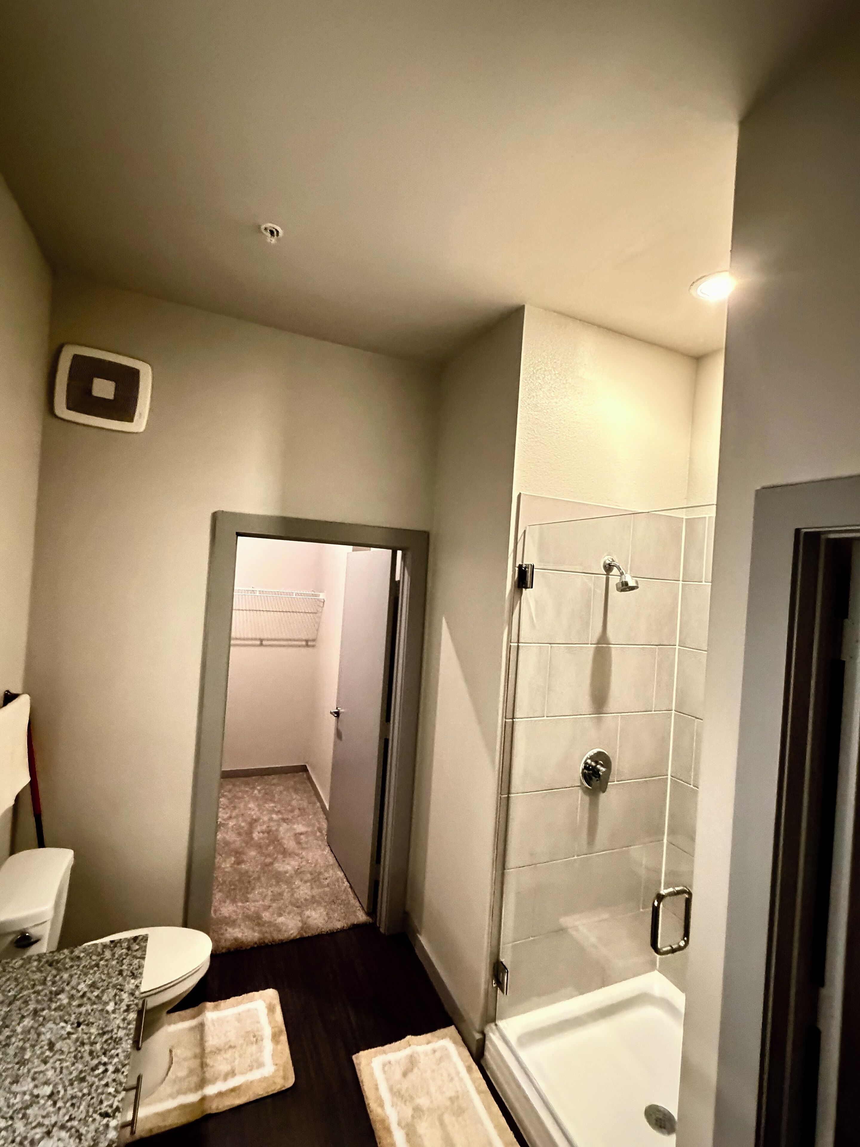 A bathroom with a shower, toilet, and sink.