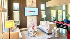 A modern living room with a sofa, coffee table, and a pool table. - Relaxing & Luxurious Private Oasis w heated Pool/Spa 10 min from Las Vegas Strip (Henderson)