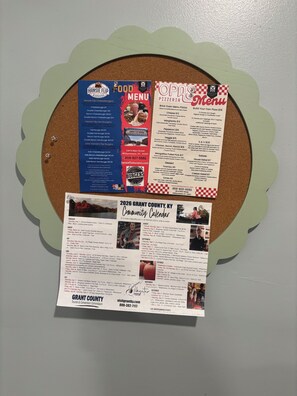 A bulletin board with a food menu, a pizza menu, and a community calendar for Grant County, KY. - The Arkside Cottage - The ark, creation museum, Williamstown marina (Williamstown)