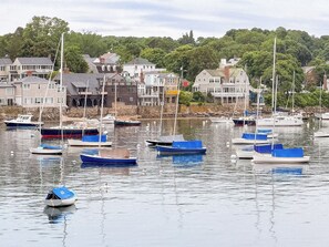 A marina with various boats docked, surrounded by residential buildings and trees. - Waterfront Retreat at Motif Annex (Rockport)