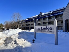 Eine schneebedeckte Gegend mit einem Schild für das Lodge Condominium Hotel.