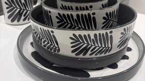 A set of black and white patterned bowls on a white table.