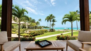 A resort balcony with a view of a pool, palm trees, and the ocean. - Bessa | Ocean View Villa | 2BR, Seaside Pool ➠ U52 (Oracabessa)