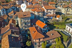 An aerial view of a residential area with closely packed houses, each featuring red-tiled roofs and balconies. - Quadrifoglio Stresa Hill with A/C and Sunny Balcony, Stresa, Italy (Stresa)