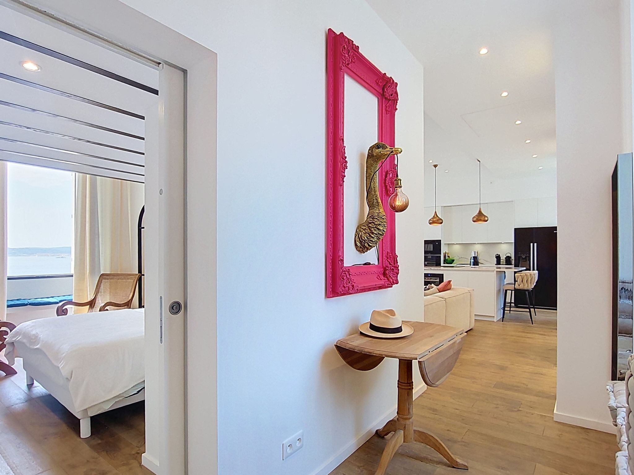 A modern interior with a bed, a dining area, and a kitchen.