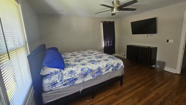 A bedroom with a bed, a ceiling fan, a TV, and a fireplace. - 10 mins from Mercedes Benz stadium! (Atlanta)