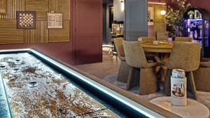 A bar area with a bar counter, chairs, and a can of beer on a table. - Movie Theater • Tennis • Barrel Sauna • Hot Tub (Templeton)
