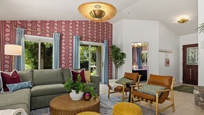 A living room with a sofa, armchairs, a coffee table, and a patterned rug. - Movie Theater • Tennis • Barrel Sauna • Hot Tub (Templeton)