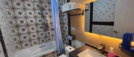 A modern bathroom with a shower, toilet, and sink.