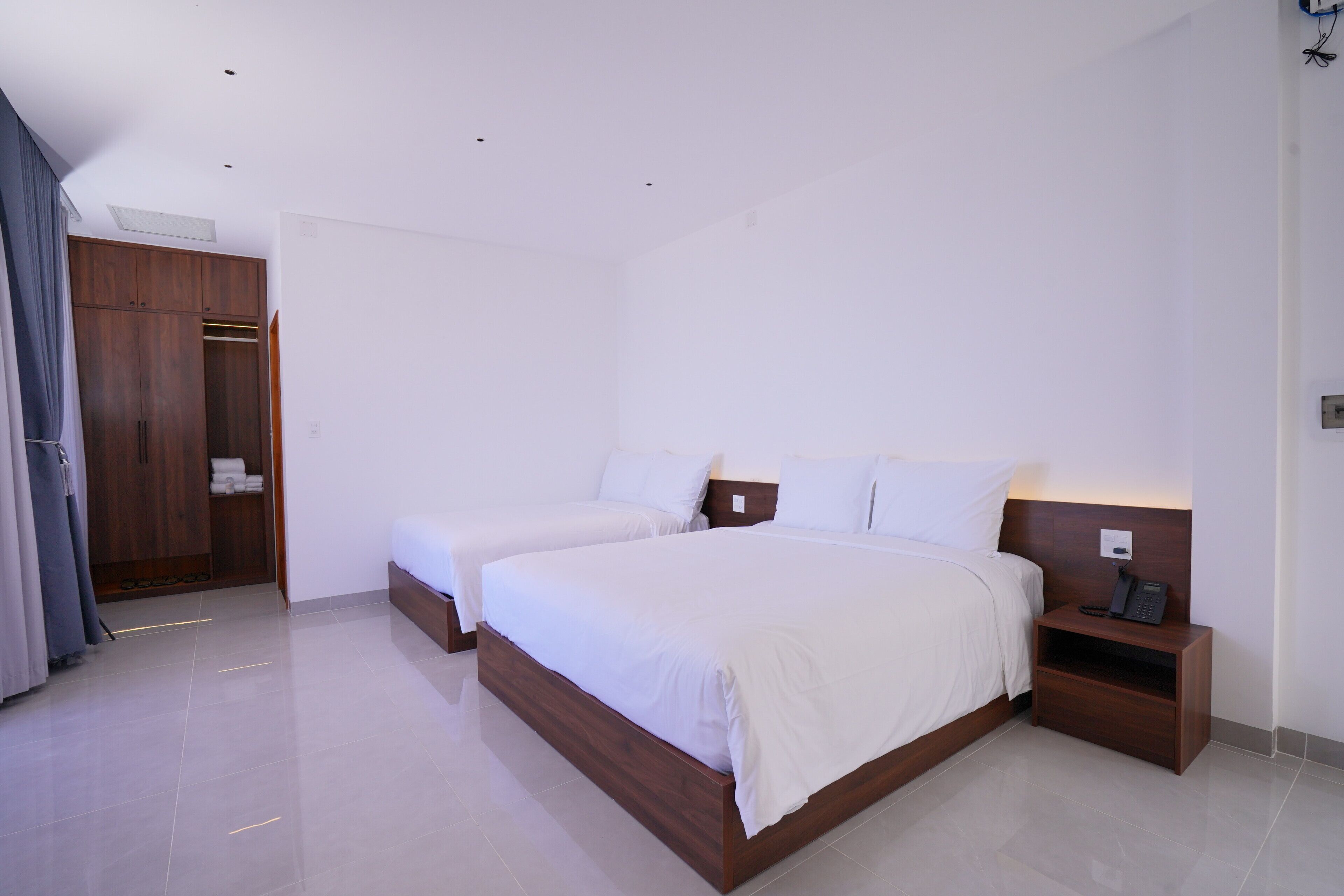 Deluxe Triple Room, Multiple Beds, Sea View | Minibar, in-room safe, laptop workspace, blackout drapes
