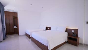 Deluxe Triple Room, Multiple Beds, Sea View | Minibar, in-room safe, laptop workspace, blackout drapes