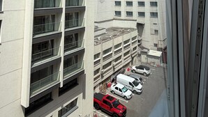 A multi-story building with a parking area below. - Limons Apartment: Living Room and Bedroom in Downtown Bucharest (București)