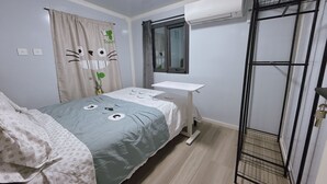 A bedroom with a bed, a bedside table, a window, and an air conditioning unit. - Cute Totoro theme Tiny House (Rowland Heights)