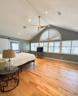 A spacious bedroom with a large bed, a ceiling fan, and a TV on a stand. - Gorgeous Coastal Style 4-bedroom house in Dana Point perfect for your getaway (Dana Point)