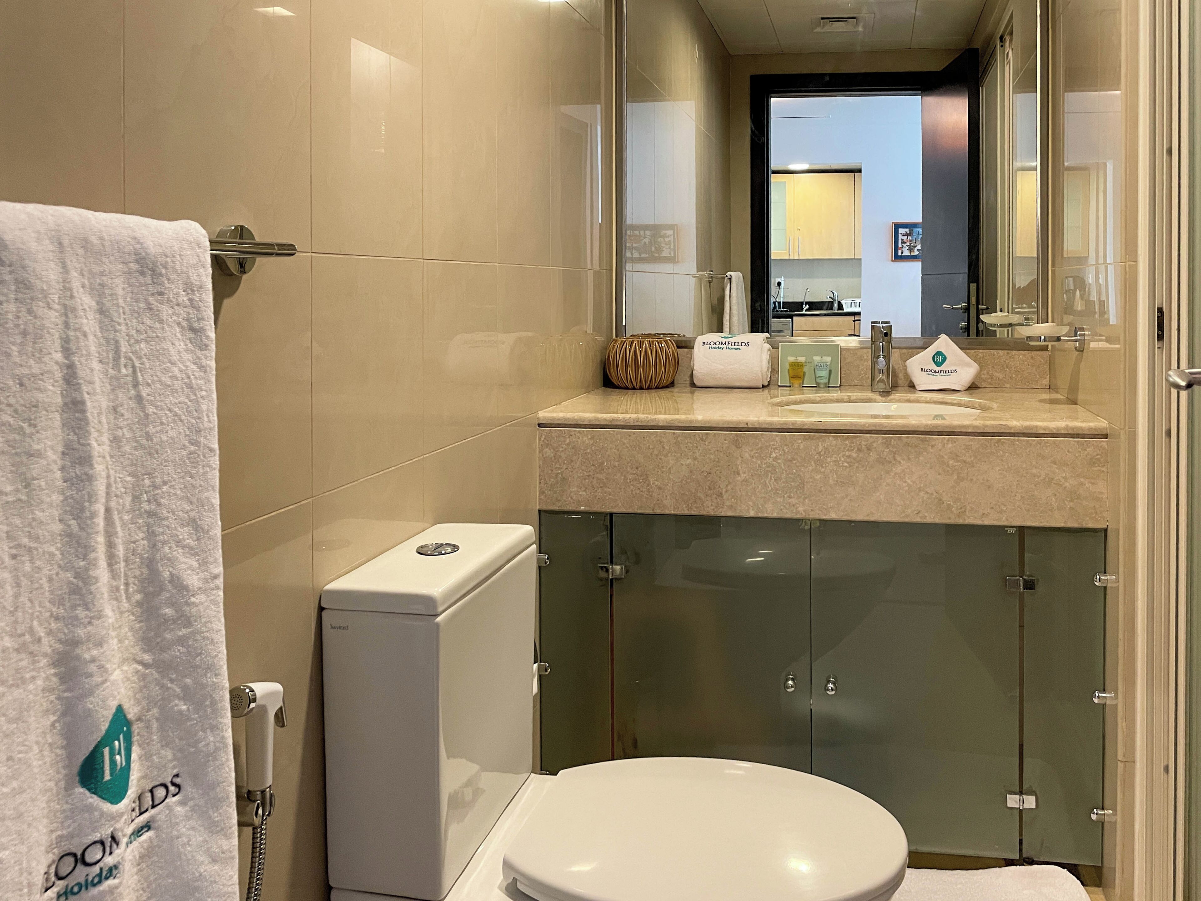 A modern bathroom with a toilet, sink, and shower.