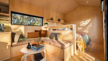 A cozy living area with a sofa, a coffee table, and a television.