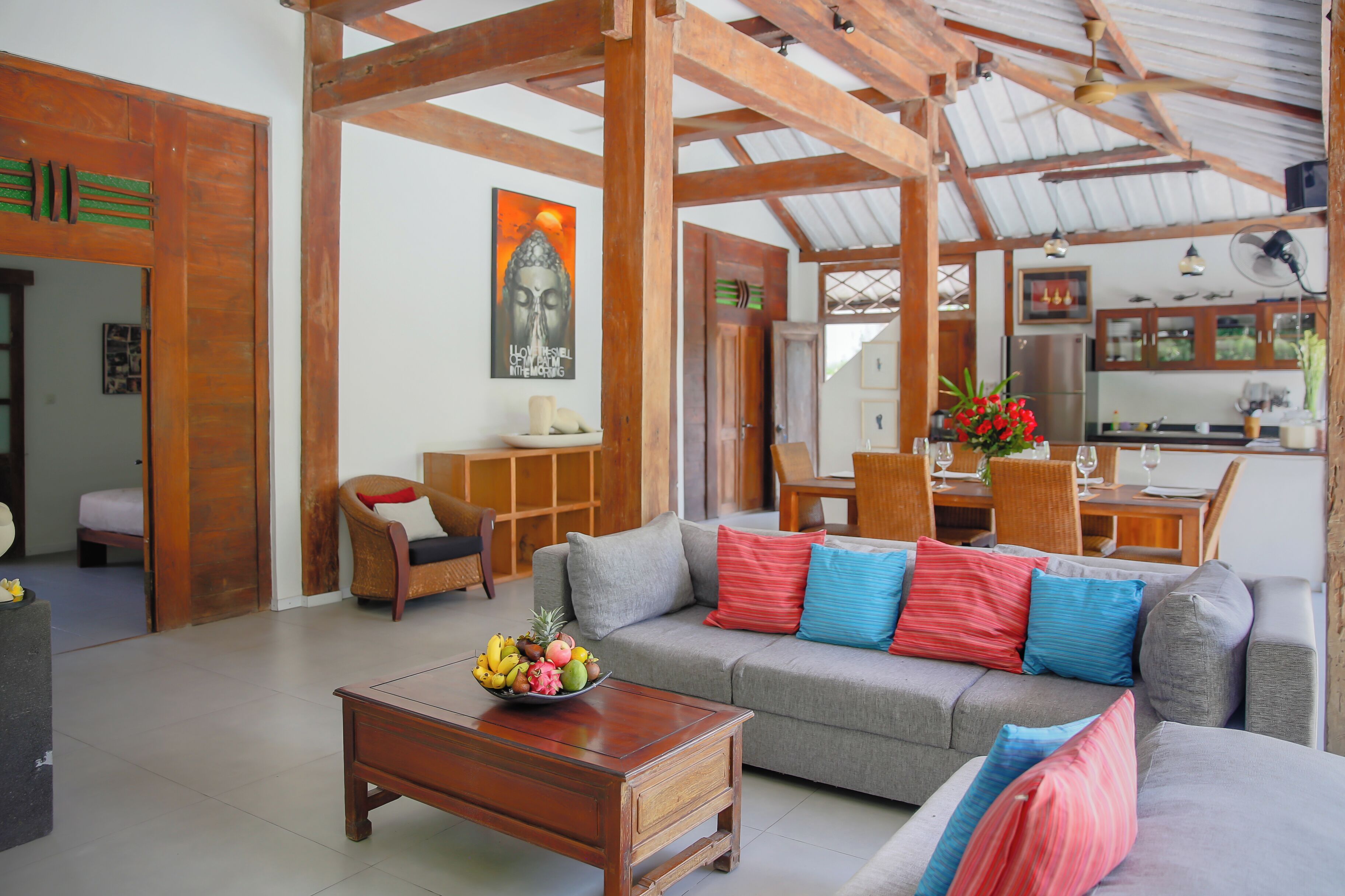 A spacious living area with a sofa, coffee table, and dining area.