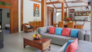 A spacious living area with a sofa, coffee table, and dining area. - Villa Sara (Badung)