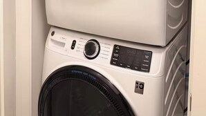 A stacked washer and dryer unit with a control panel and a digital display. - Cozy Studio Apt 1.5 Miles to Mercedes Benz Stadium (Atlanta)