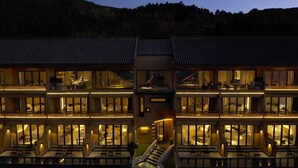 Un hotel de varios pisos con un atrio central, balcones y una escalera.
