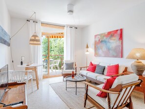 A modern living room with a sofa, chairs, a coffee table, and a balcony with outdoor seating. - Apartment Cofisa by Interhome (Jávea)