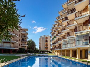 A residential building with multiple balconies, a swimming pool, and a clear blue sky. - Apartment Cofisa by Interhome (Jávea)