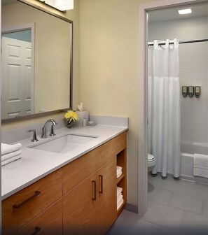 A modern bathroom with a double sink vanity, a mirror, a towel rack, and a shower area with a curtain. - Memorable Vacation, Short Drive To Arlington Heights Historical Museum! (Schaumburg)