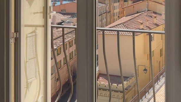 A balcony with a view of a cityscape, a metal railing, and a door. - FRGK - SUQUET DUPLEX WITH VIEWS OF THE HARBOR AND THE PALACE - 2BR (Cannes)
