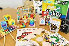 Una variedad de juguetes y libros infantiles sobre una mesa.